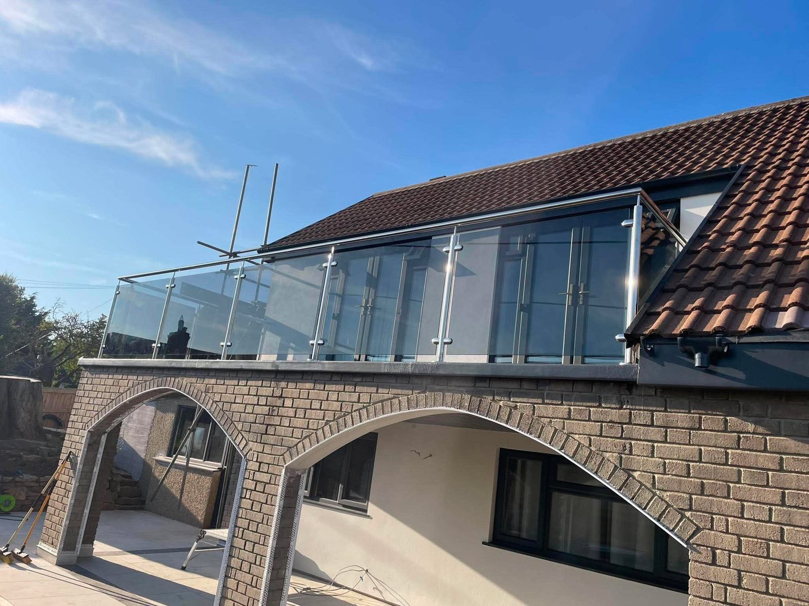 Stainless steel and glass balustrade along a first-floor balcony